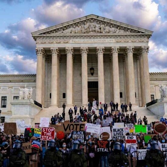 Supreme-Court-Trans-Athletes-US-Supreme-Court-building-with-protesters-holding-signs-about-transgender-athletes-and-womens-sports-rights-during-landmark-2026-case-hearing
